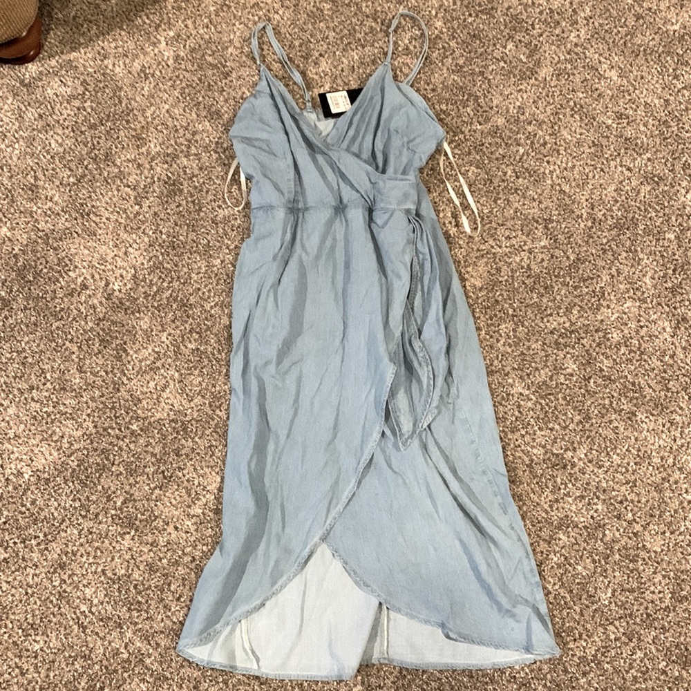 A little past the knees, light colored jean dress
